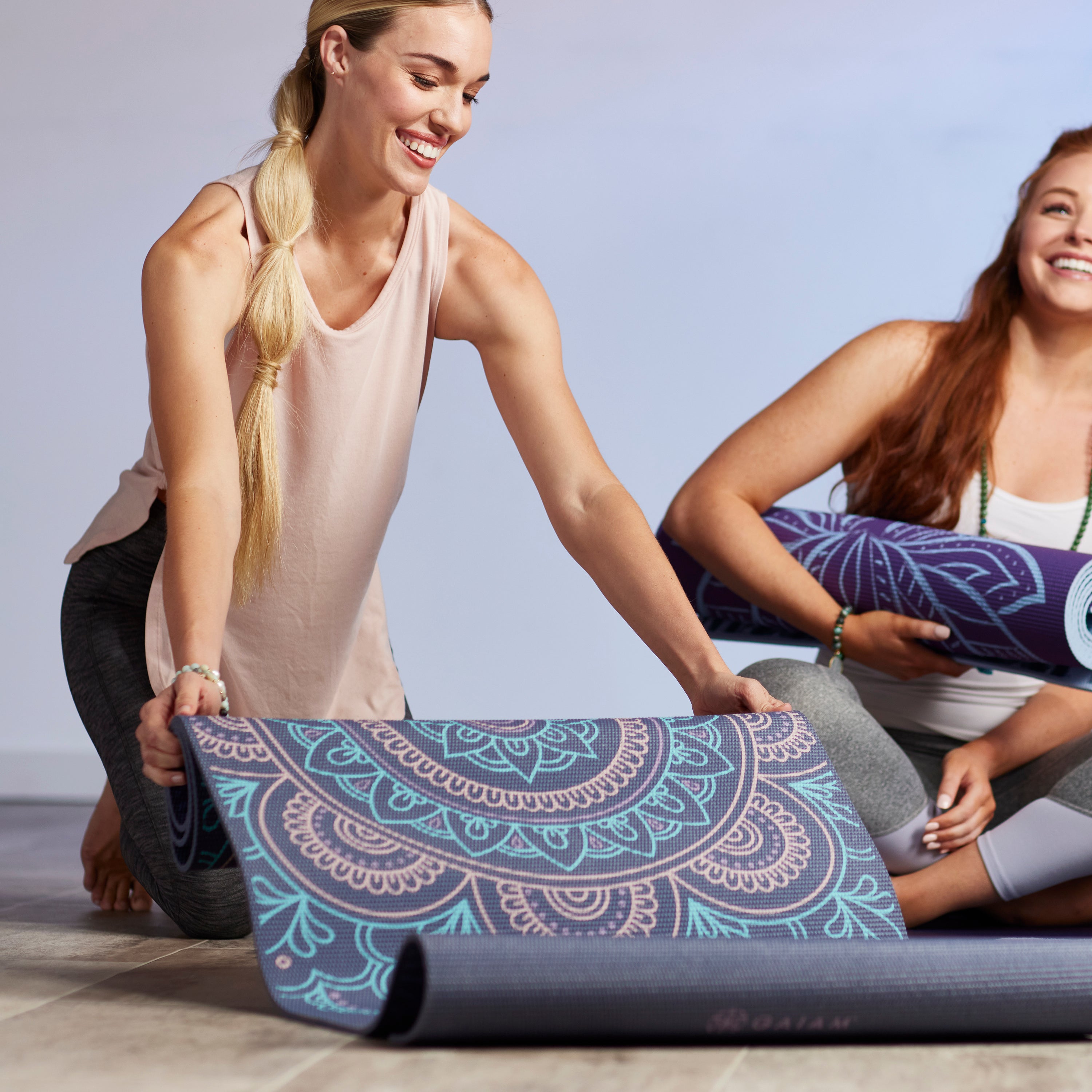 Woman unrolling yoga mat